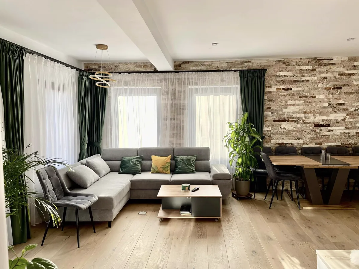 Living room with sofa and stone wall