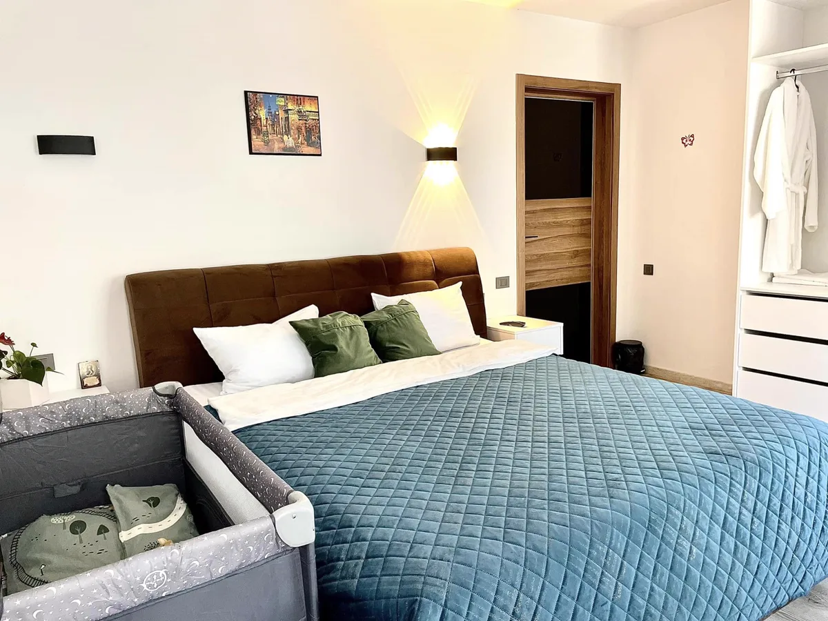 Master bedroom with blue upholstered bed