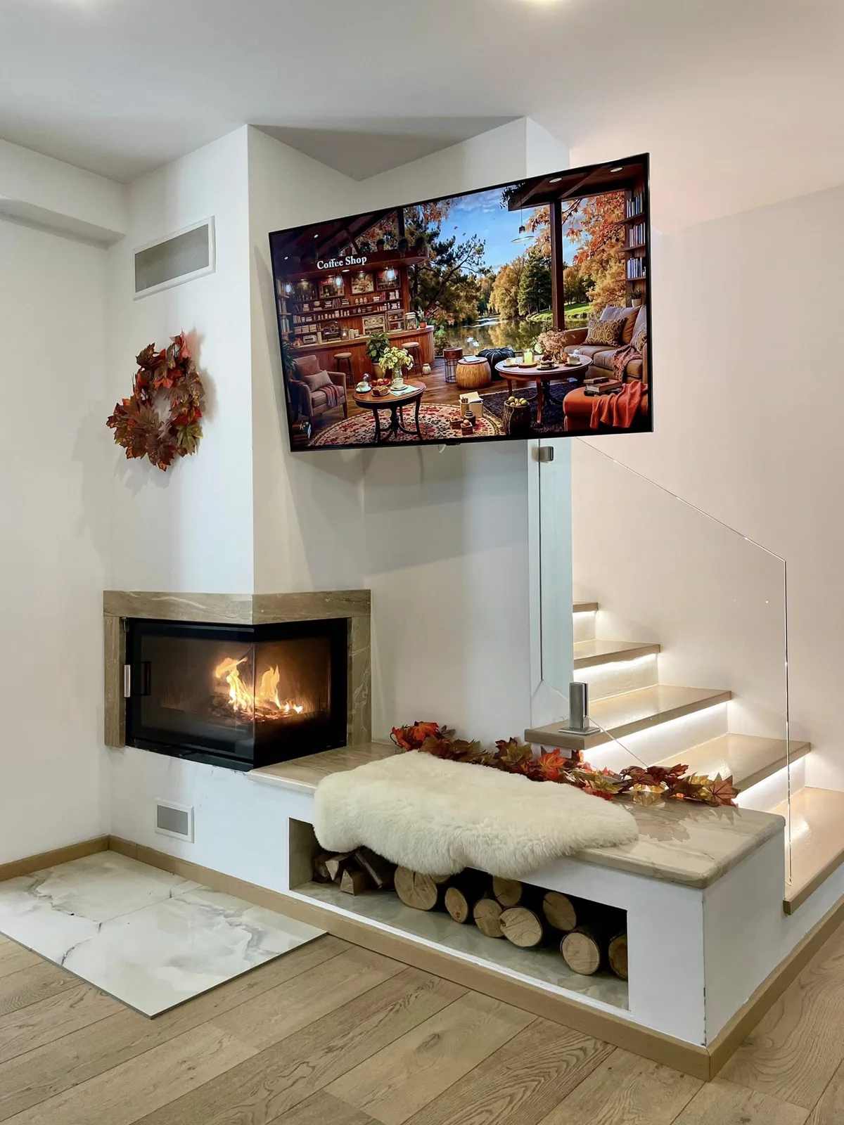 Fireplace with TV above and LED staircase — autumn décor