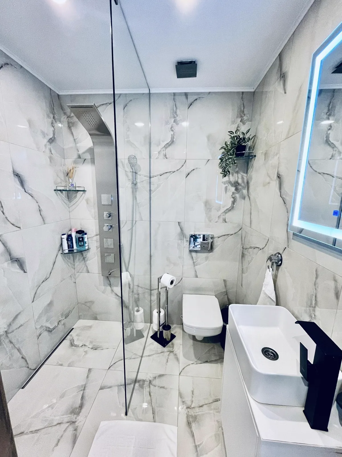 Bathroom with fine tiling and rainfall shower