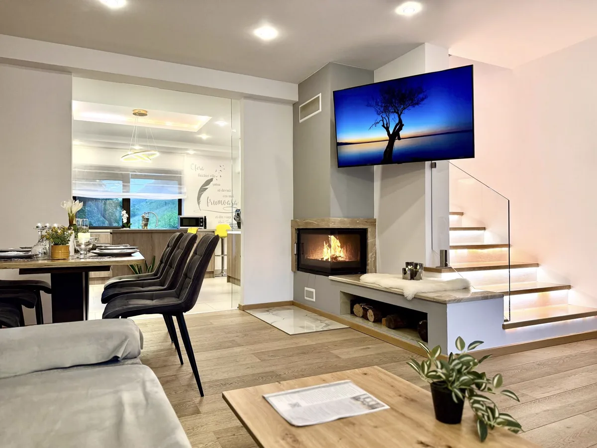 Living room with Smart TV, fireplace and illuminated staircase